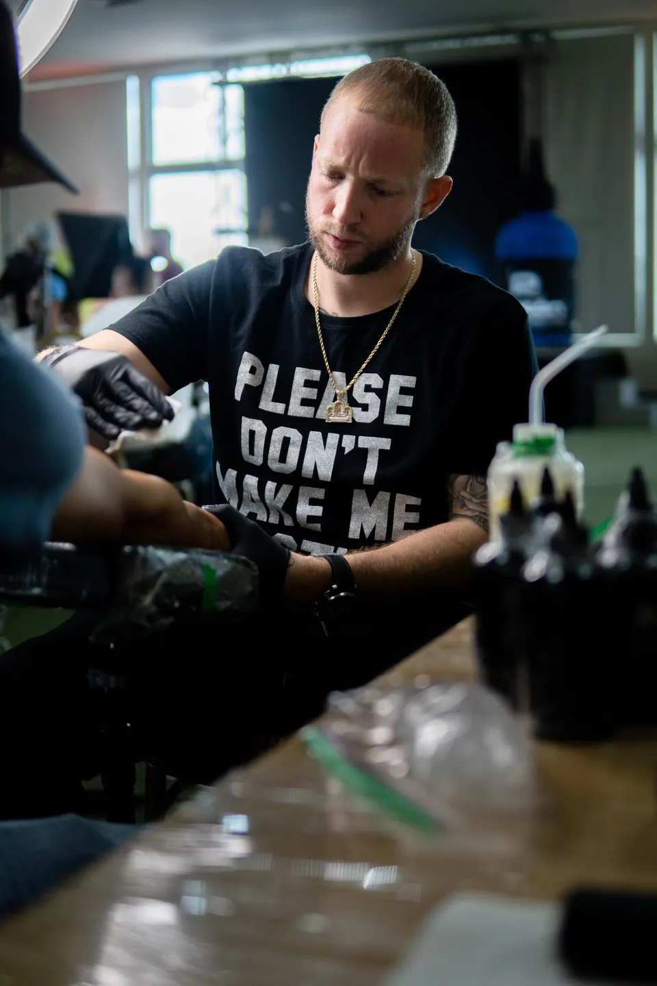 Tattoo artist working with a customer